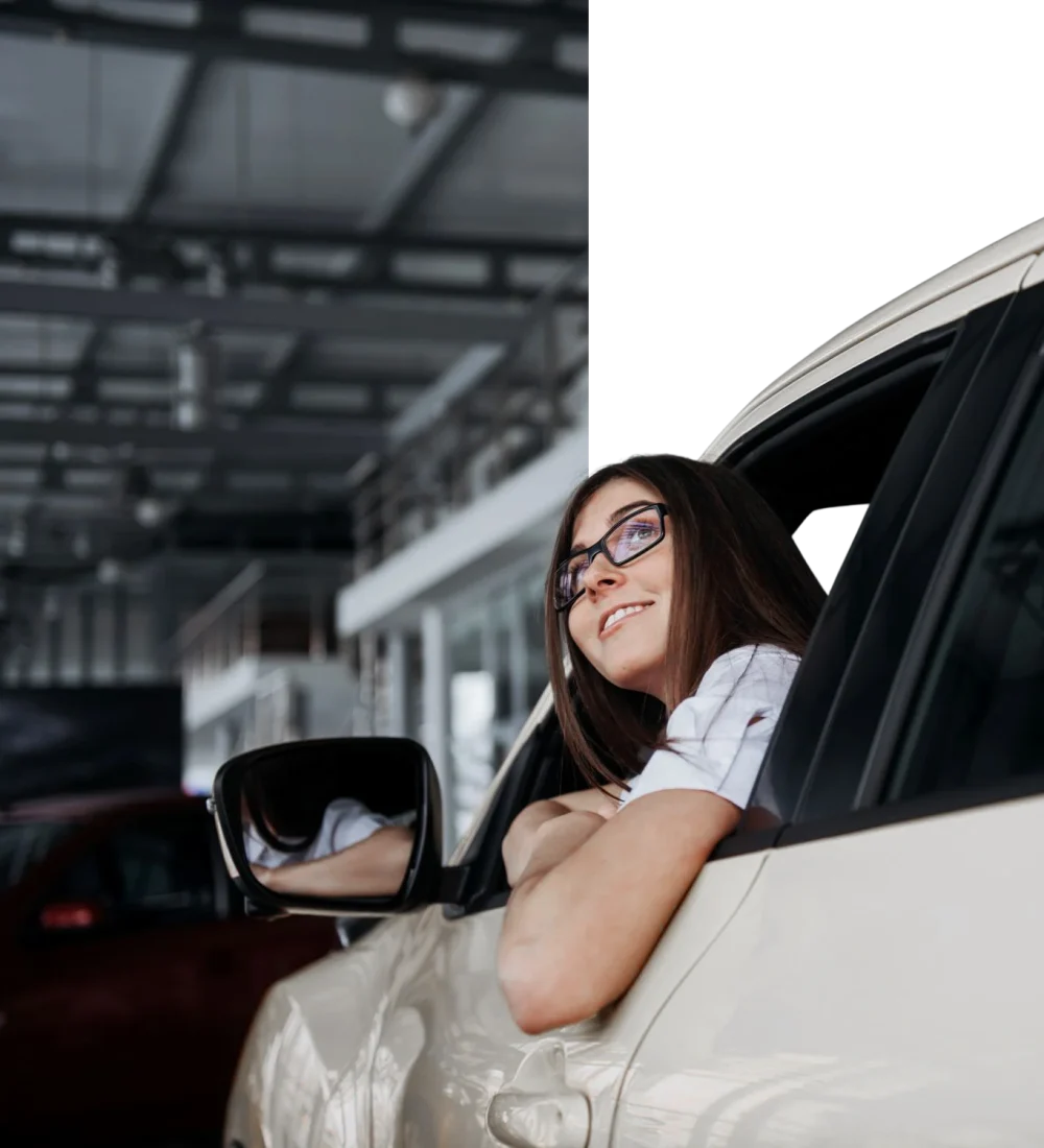smiling-woman-inside-a-yellow-car-looking-up-2026-01-09-00-39-43
